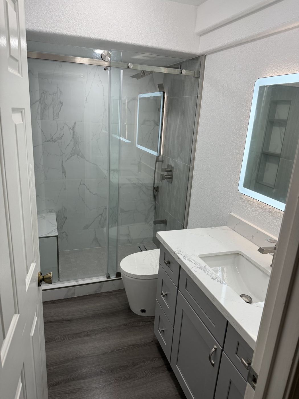 Marble-look shower, LED mirror and new vanity
